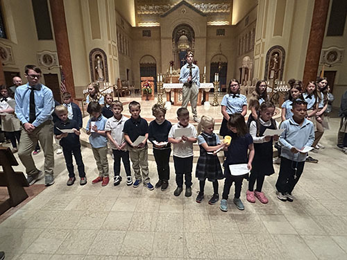 Group of students in a line in front of the altar