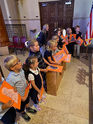 Students singing Happy Birthday to St. Mary