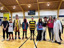 Students lined up in the gym with Halloween costumes on