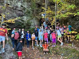 Group photo standing in front of rocks
