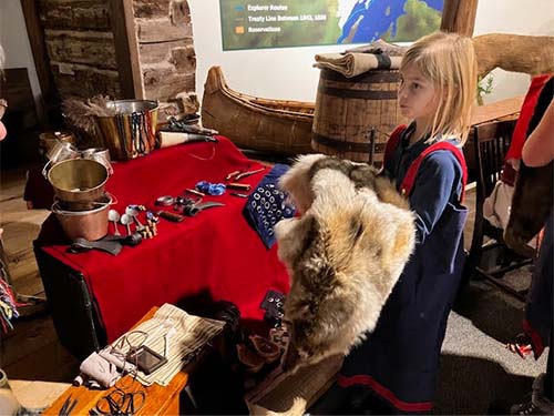 student holding animal pelt