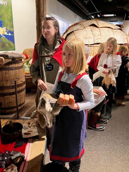 one student holding soap and animal pelt