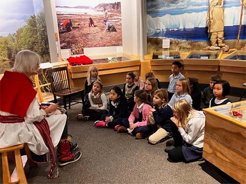 students gathered around listening