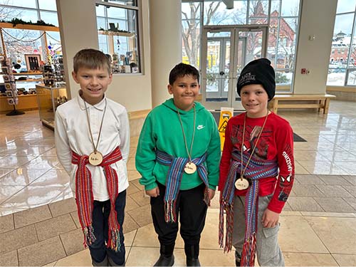 Three students with belts on