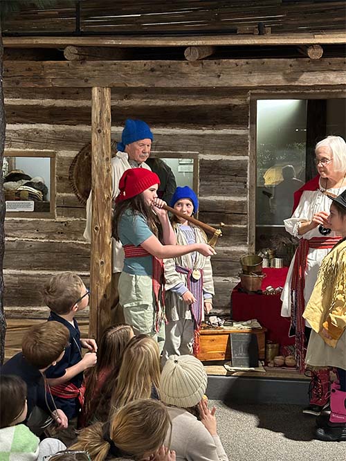 student in costume playing an instrument