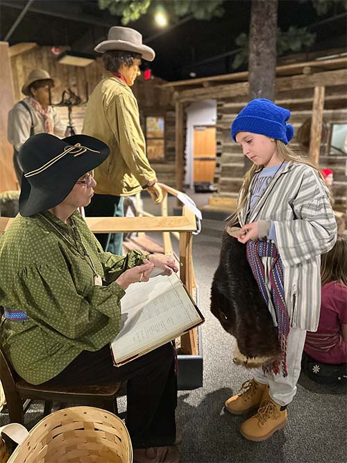 student listening to an elder read