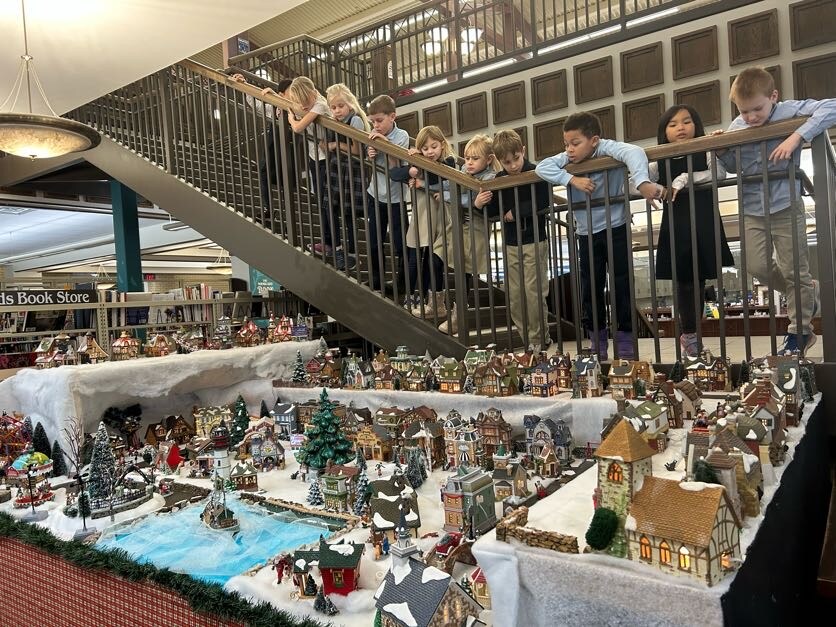Second grade students visiting the local library looking at the Chrismas Village display