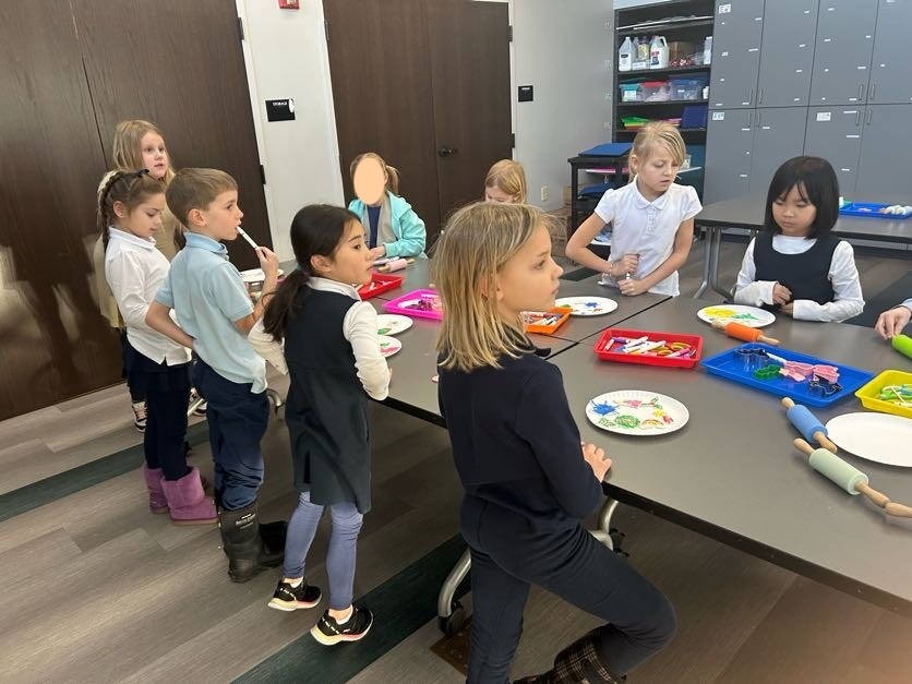 Students enjoying a craft activity at a table in the library