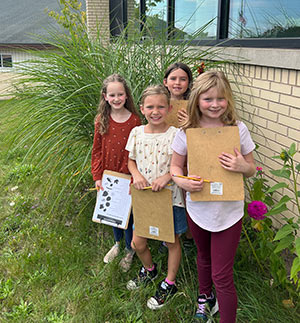 Four girls with their note pads for the scavenger hunt