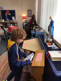 boy standing and looking at papers