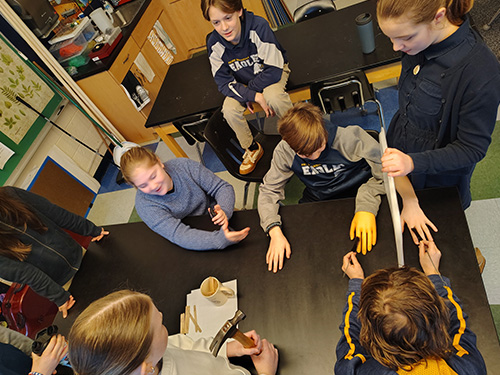 students building a display with gloves