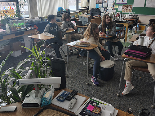 Students talking at their desks