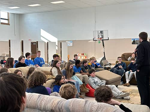 Students listening to an adult