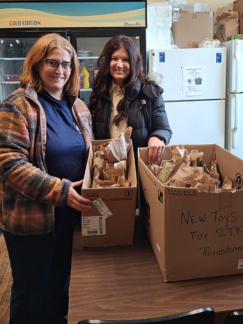 Miss Jennie and Miss Christina with coffee mug service project boxes