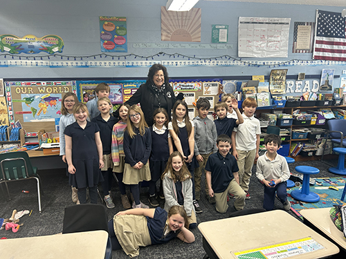 Second grade class posing for a picture with Mrs. Tavernini