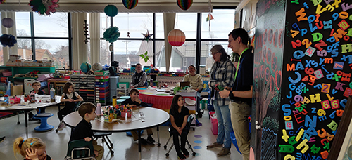 Seminarian visiting younger students in the classroom