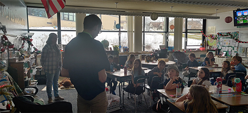Seminarian visiting students at school