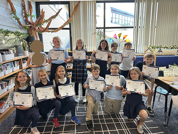 Group of proud students holding their Disciple of Christ awards
