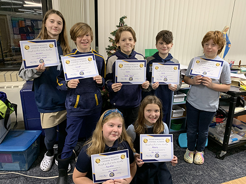 Seven students proudly holding their certificates