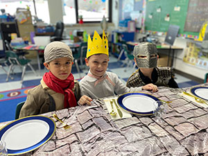 Three students dressed as a rogue, a king, and a knight