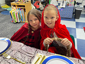 Two students dressed as red riding hood