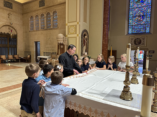 Students learning about the altar