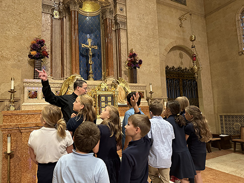 Father Tim giving students a tour of the Saint Peter's Cathedral