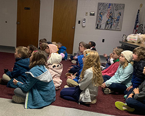 students sitting on classroom floor