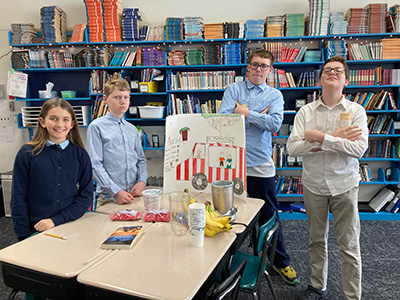 Food Truck Event Team - 4 students with a poster and food display