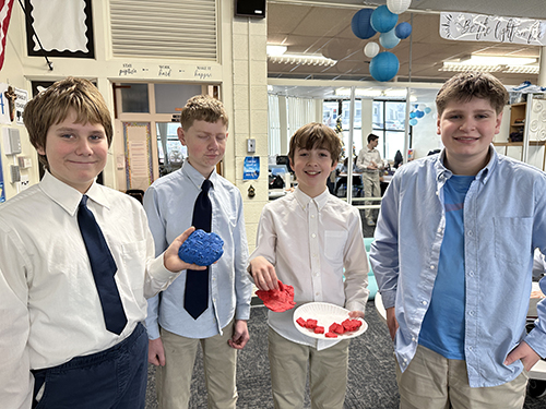 Four happy boys posing for a picture