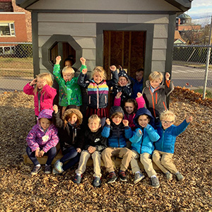 Elementary students in front of their new playhouse