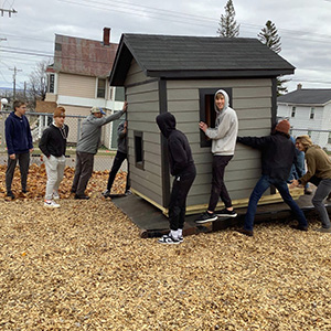 MSHS students removing new playhouse from truck