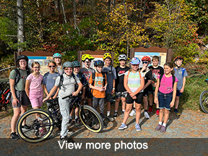 Students with bikes standing in front of trail signs