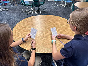 Two girls with their prayer cards and rosaries