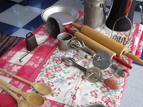 Table in the classroom displaying old fashion kitchen tools