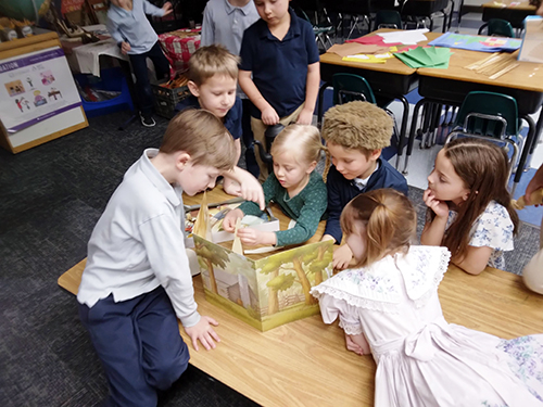 Group of happy students reading a book together