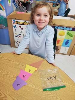 students making a paper ice cream cone with letters ADA