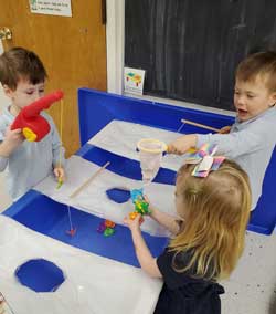 students playing toy fishing game