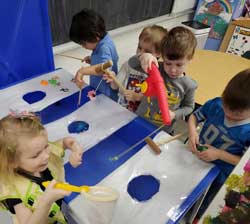 five students playing with toy fishing game