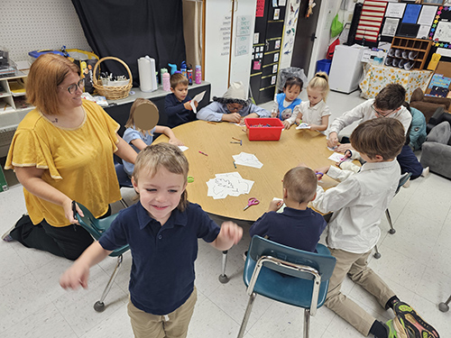 Pre-k classroom having fun with a coloring activity
