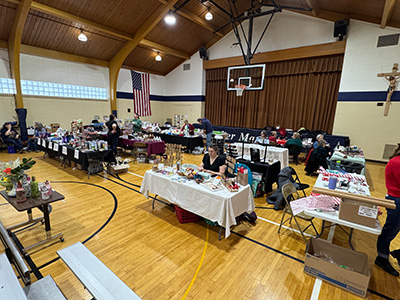 Gym with tables laden with various items for sale