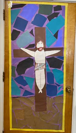 classroom door decorated with a man on a cross