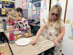 Students working with marshmallows and toothpicks