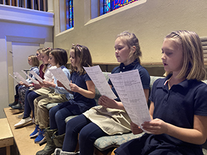 Students singing in church