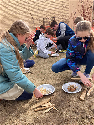 Two female students making a fiare
