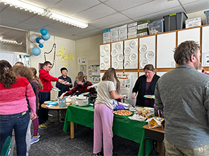 Students getting food at a buffet table