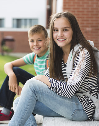 Two students sitting on steps