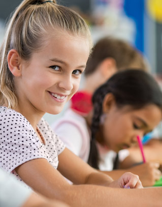 Smiling student sitting at a desk