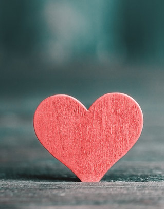 Red paper heart sitting on a table