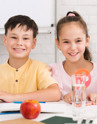Two smiling students in class